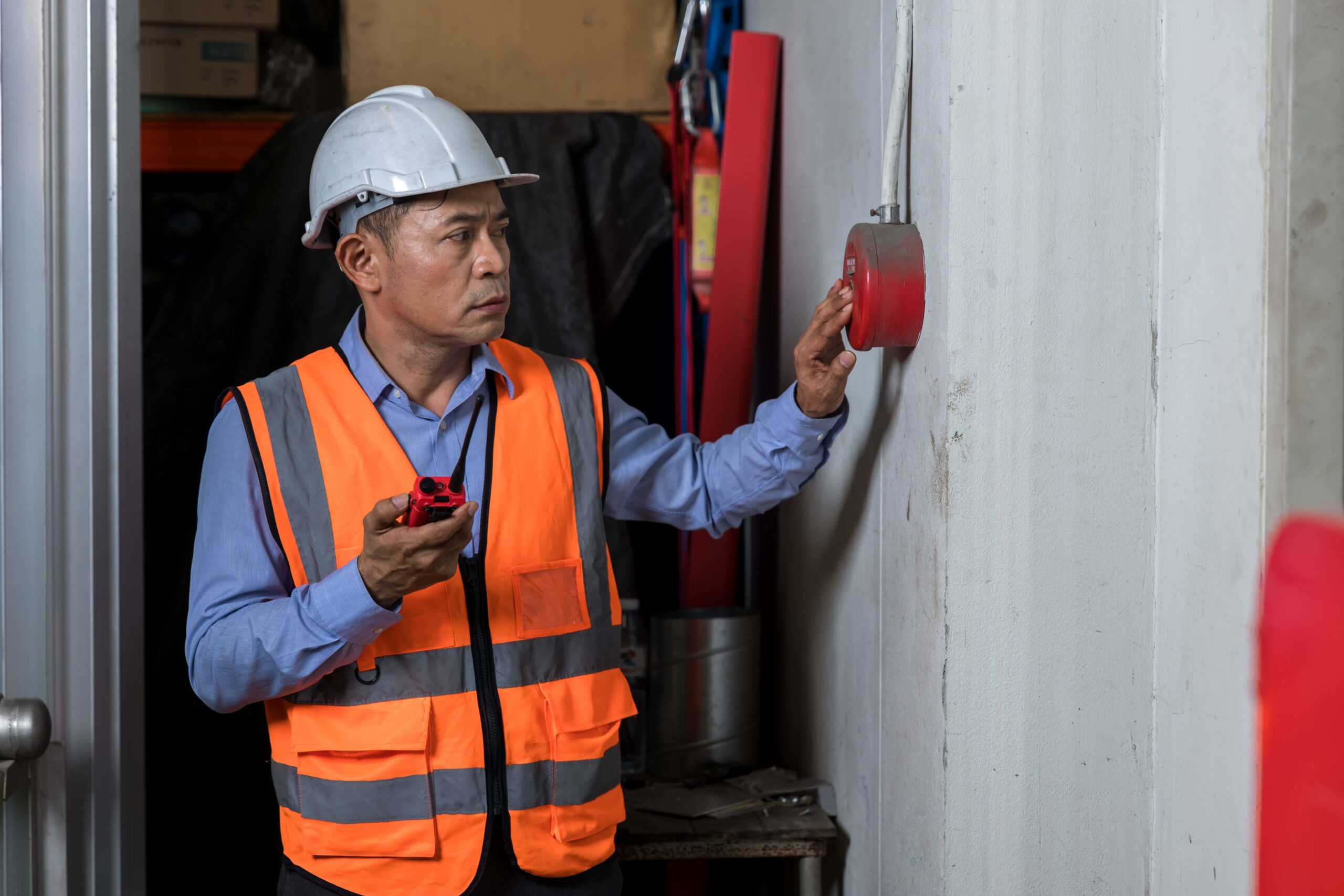 Foreman Or Worker Pushing Fire Alarm On The Wall 2023 11 27 05 11 46 Utc